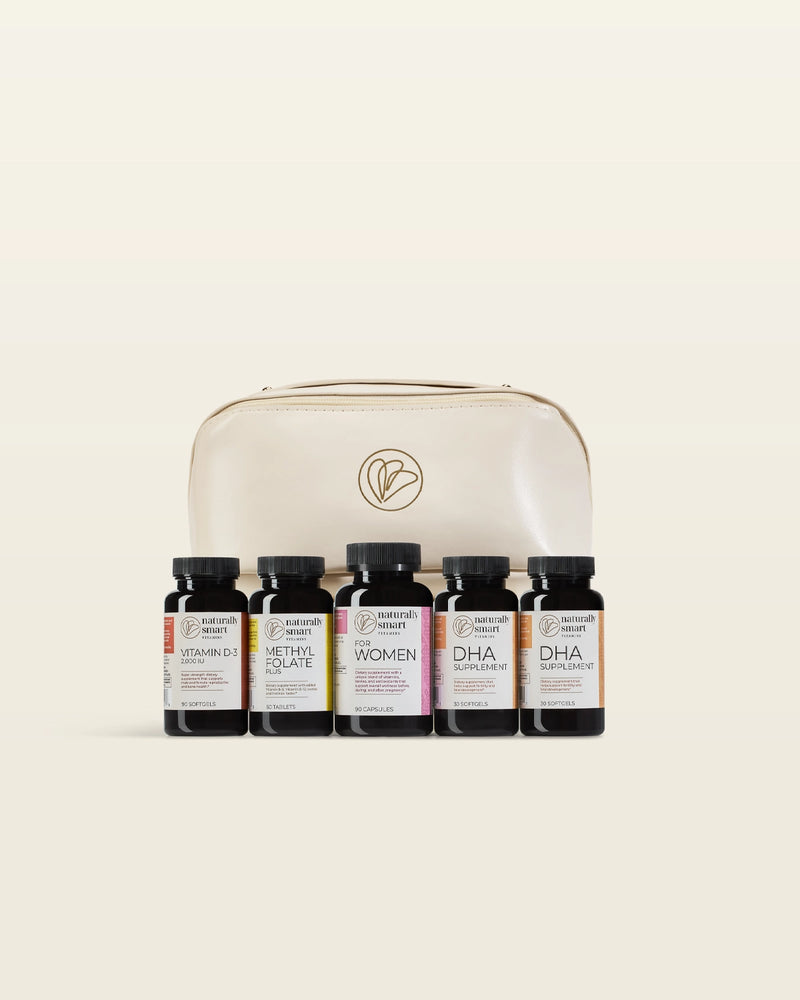 Set of supplement bottles specifically for pregnant women in front of a beige leathe carrying case on a beige background