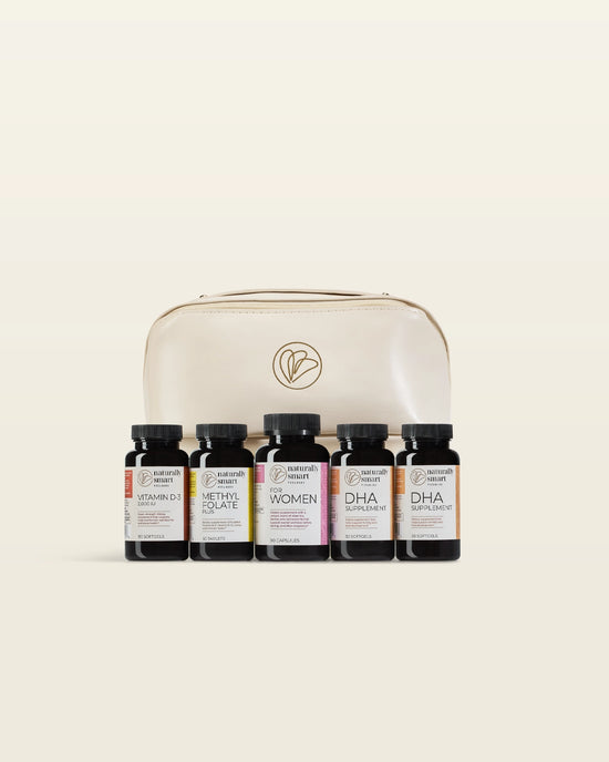 Set of supplement bottles specifically for pregnant women in front of a beige leathe carrying case on a beige background