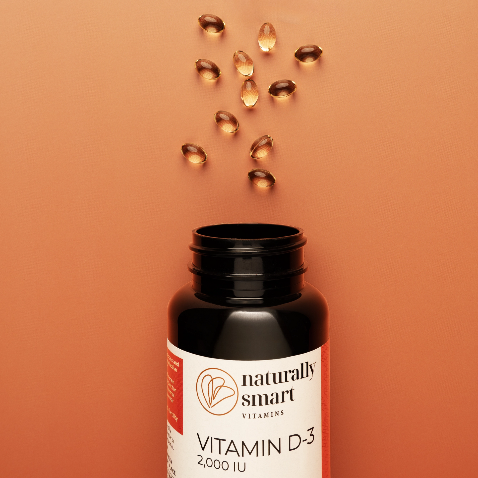Vitamin D-3 supplement bottle with capsules on an orange background