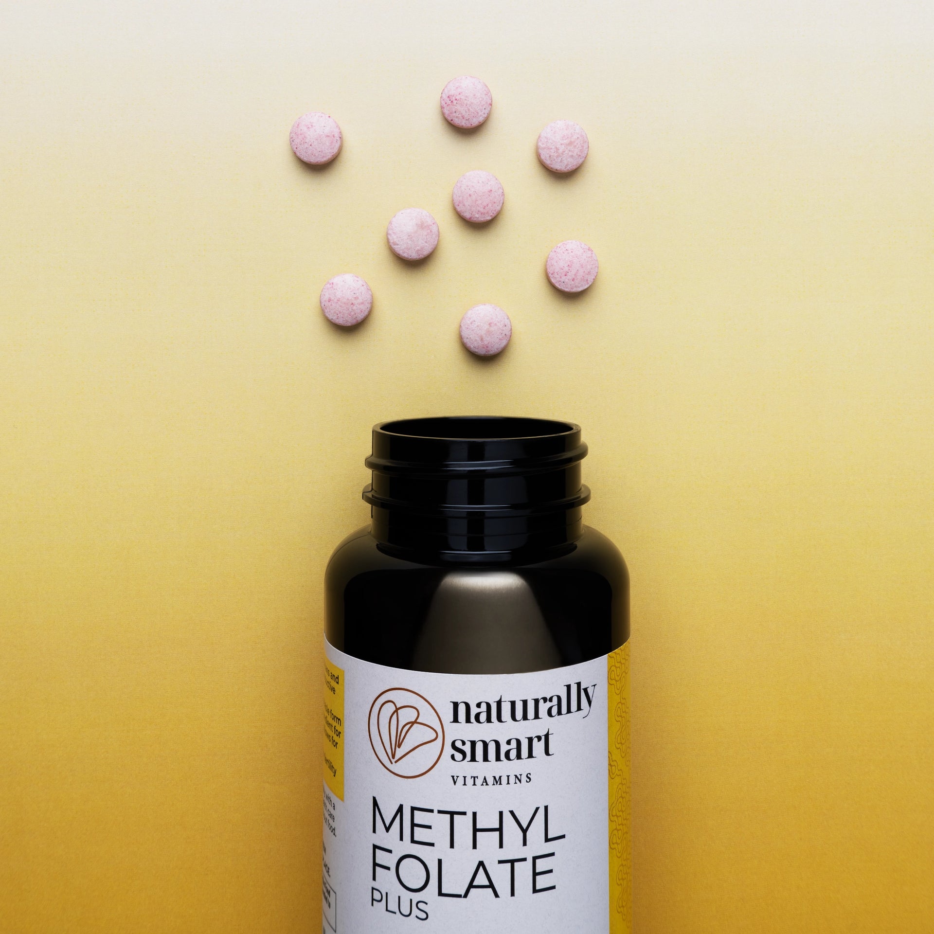 Methylfolate vitamin bottle with pink tablets on a yellow background